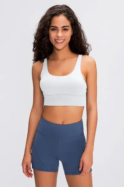 White sports bra with scoop neckline and wide shoulder straps