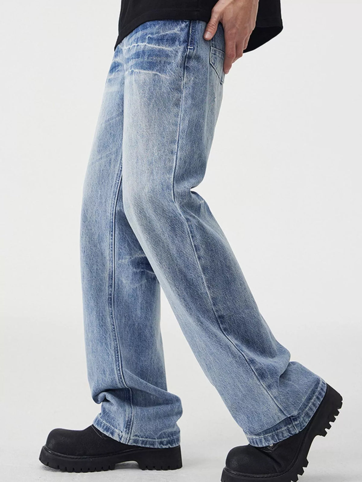 Light blue vintage wash wide-leg jeans with contrast fading, relaxed fit, and cuffed hem