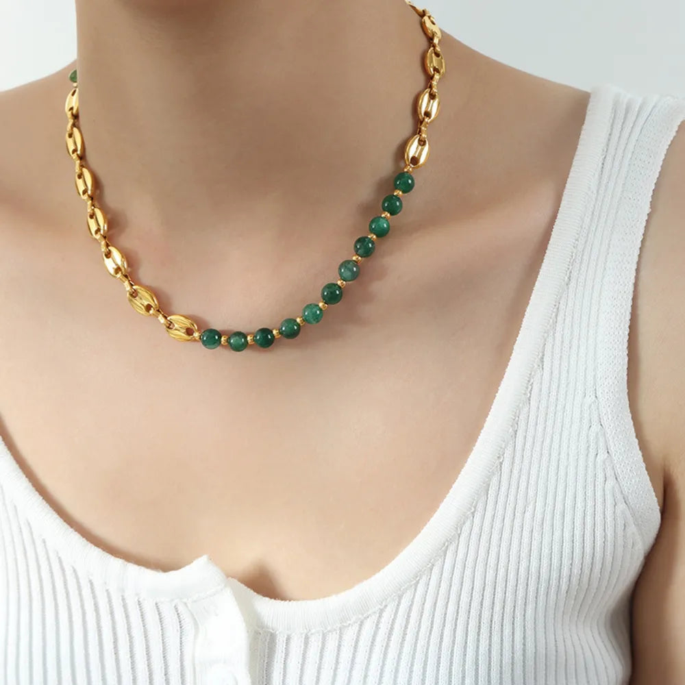 Gold beaded necklace with green round beads and alternating gold chain segments