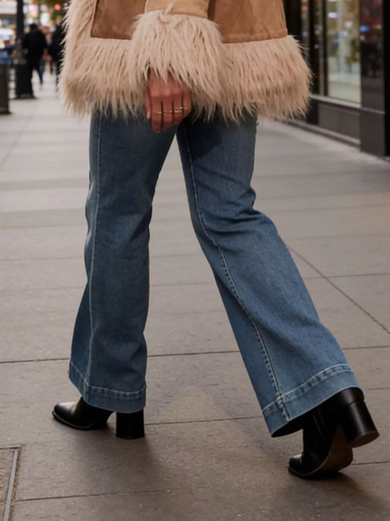Blue high-waisted flare-leg jeans with flared cuffs and side seams