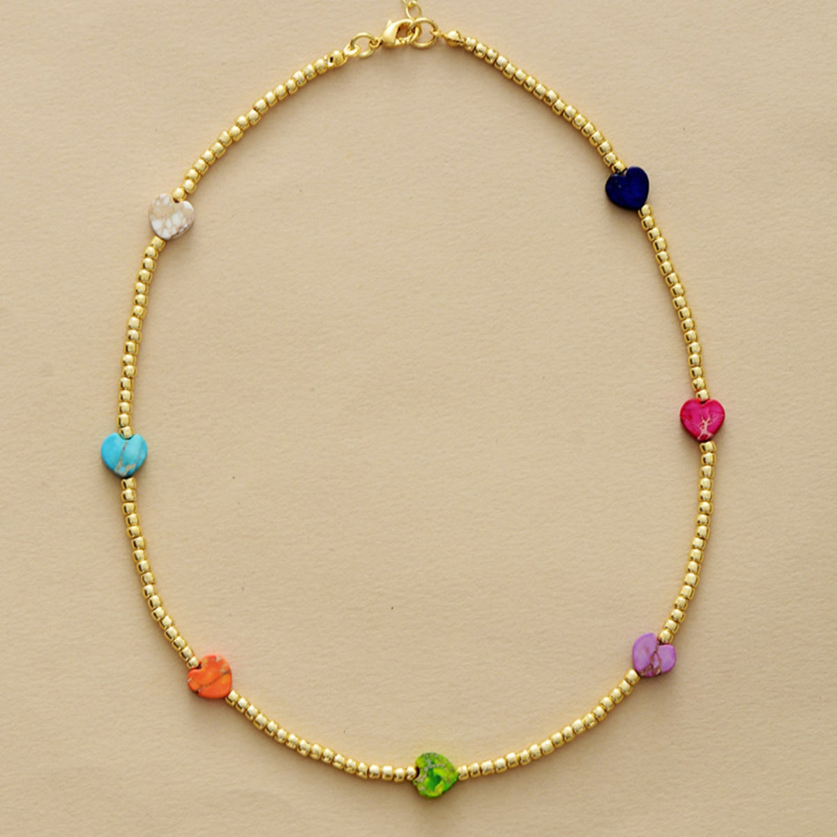 Gold-tone beaded heart-stone necklace with blue, pink, green, and orange hearts