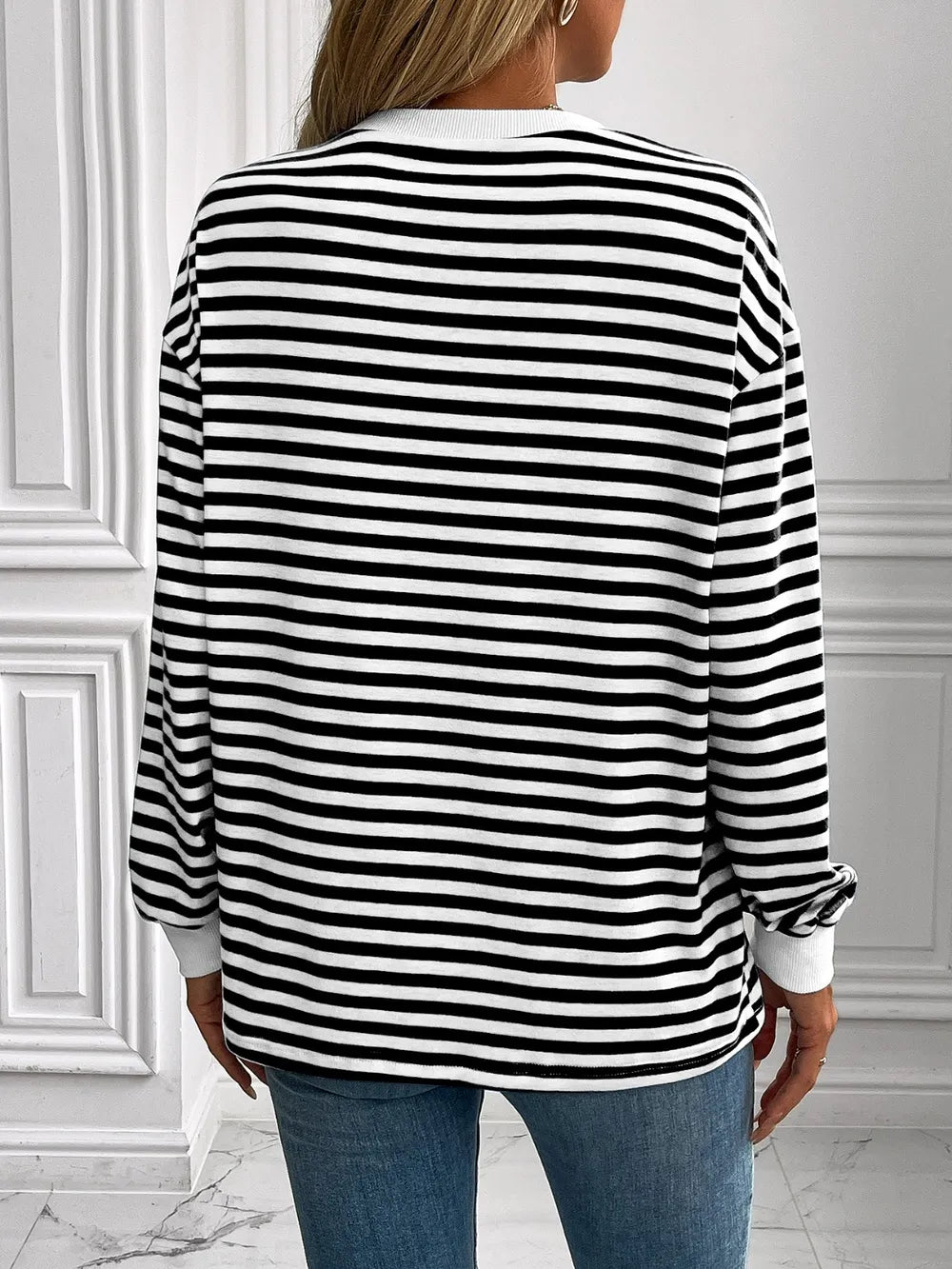 Striped crewneck long-sleeve sweatshirt in black and white, back view