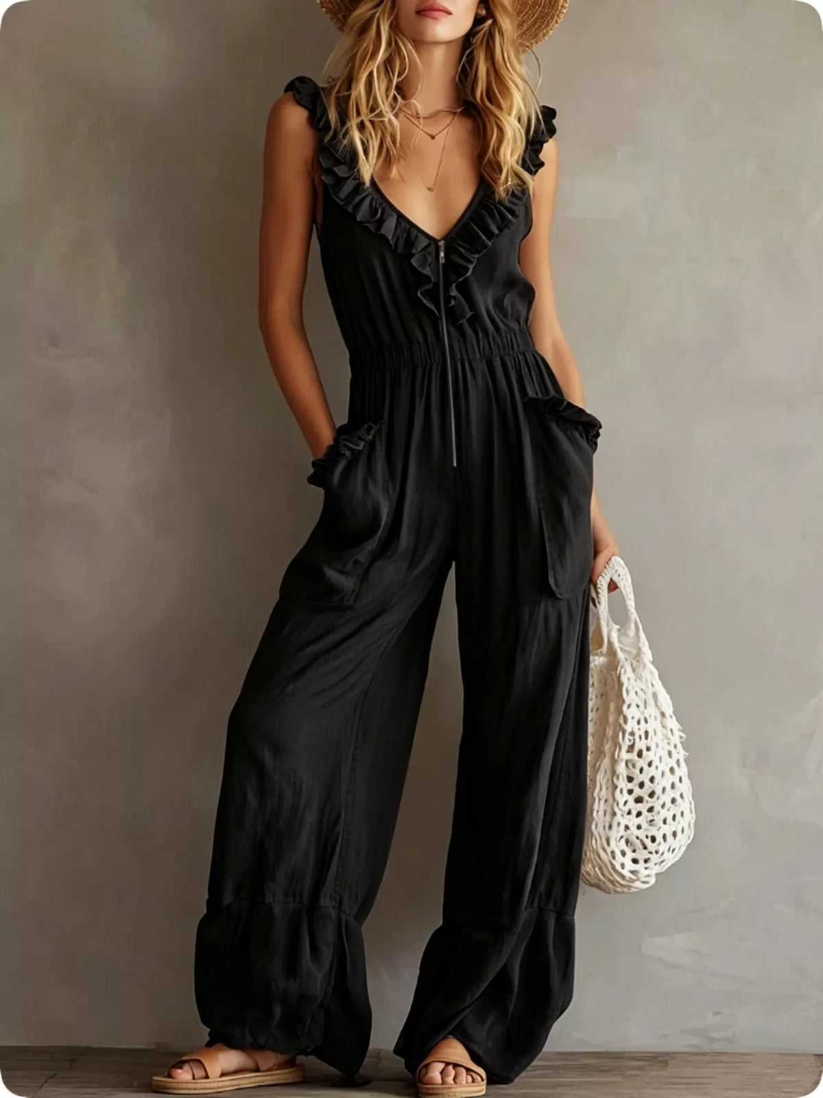 Ruffled V-neck wide-leg jumpsuit in black with gathered waist and side pockets