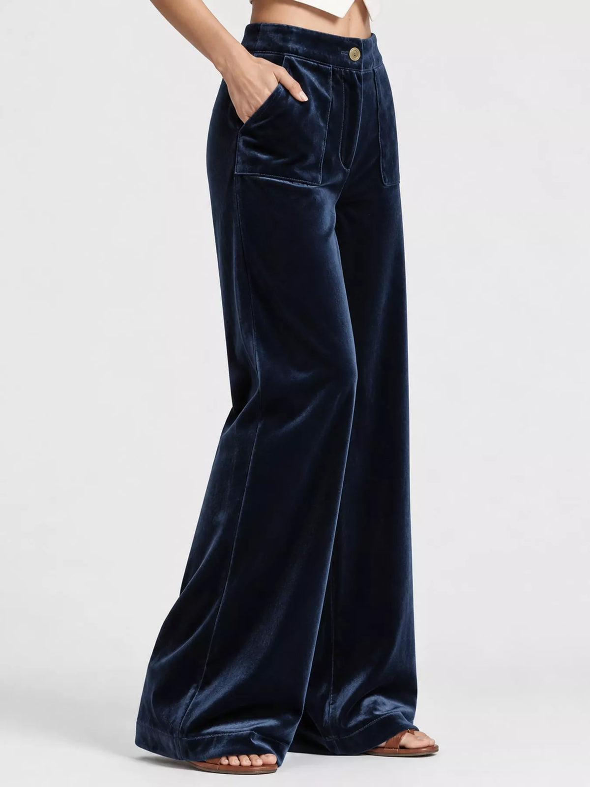 Dark blue wide-leg velvet pants, high-waisted with front pockets and button closure