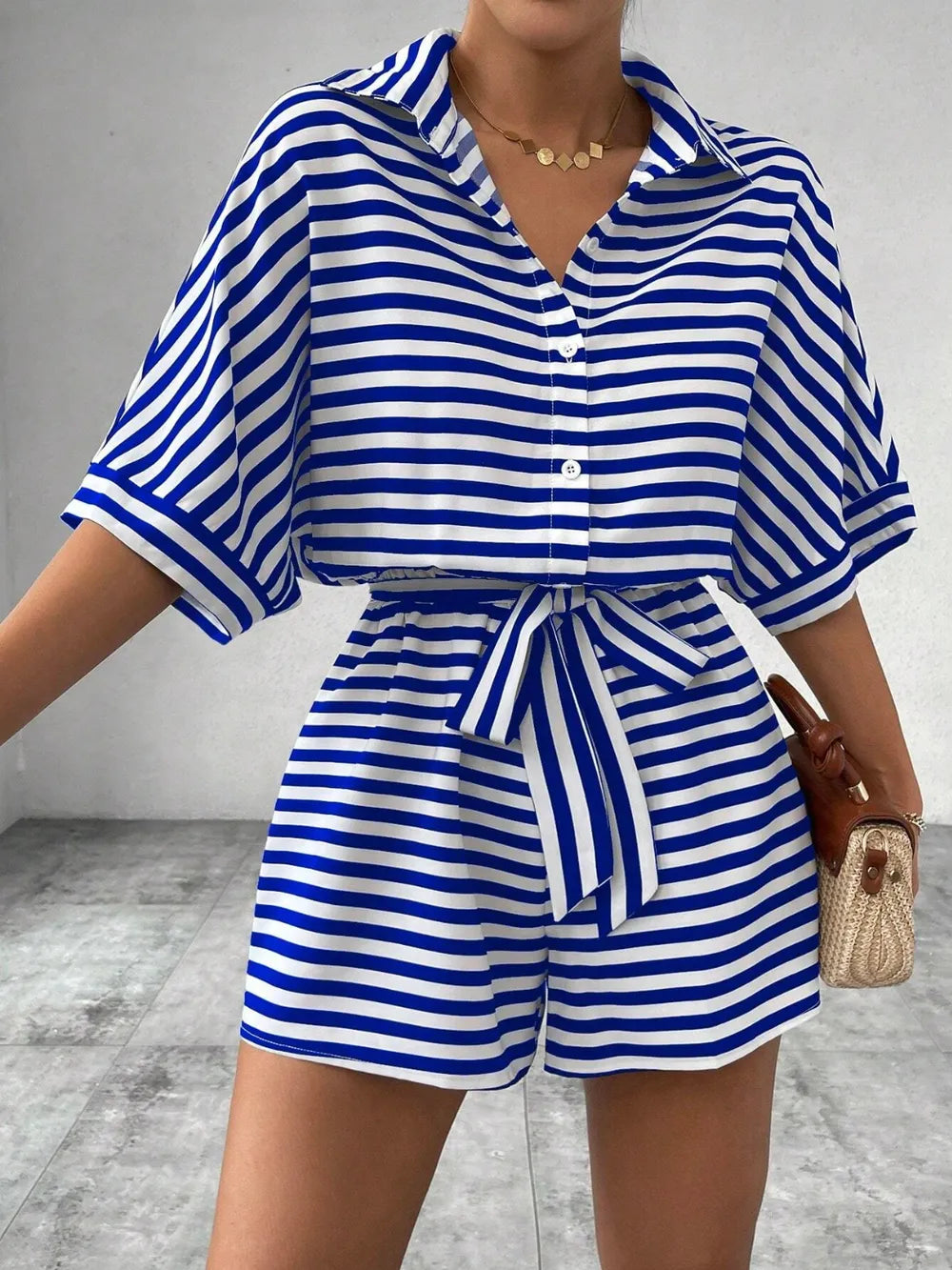 Blue-and-white striped tie-waist romper with half-button V-neck and loose sleeves