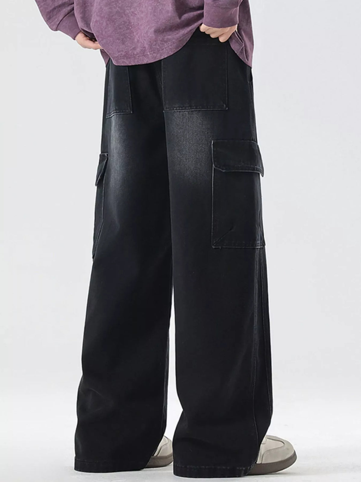 Washed black wide-leg cargo jeans with cargo flap pocket details and loose wide legs