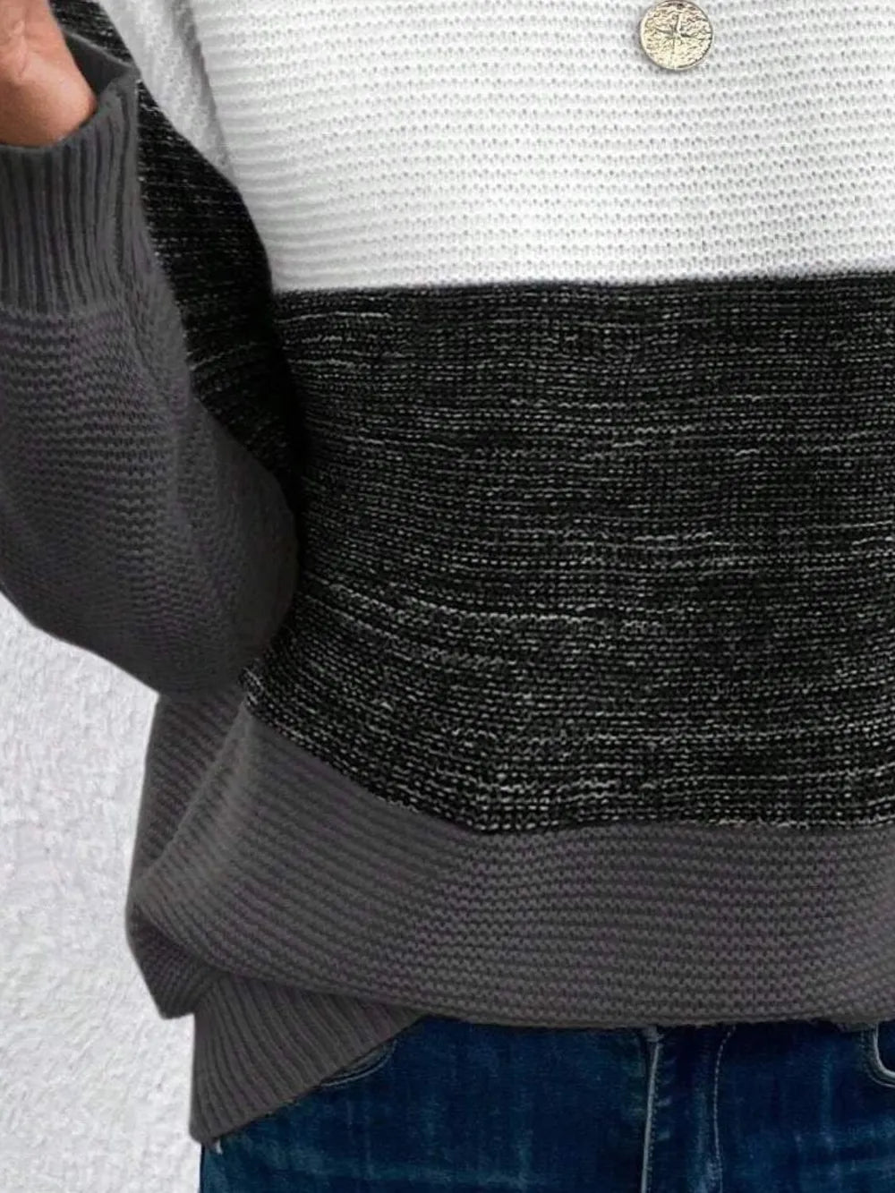 Color-block boat neck sweater close-up: dark charcoal, gray, and black knit bands.