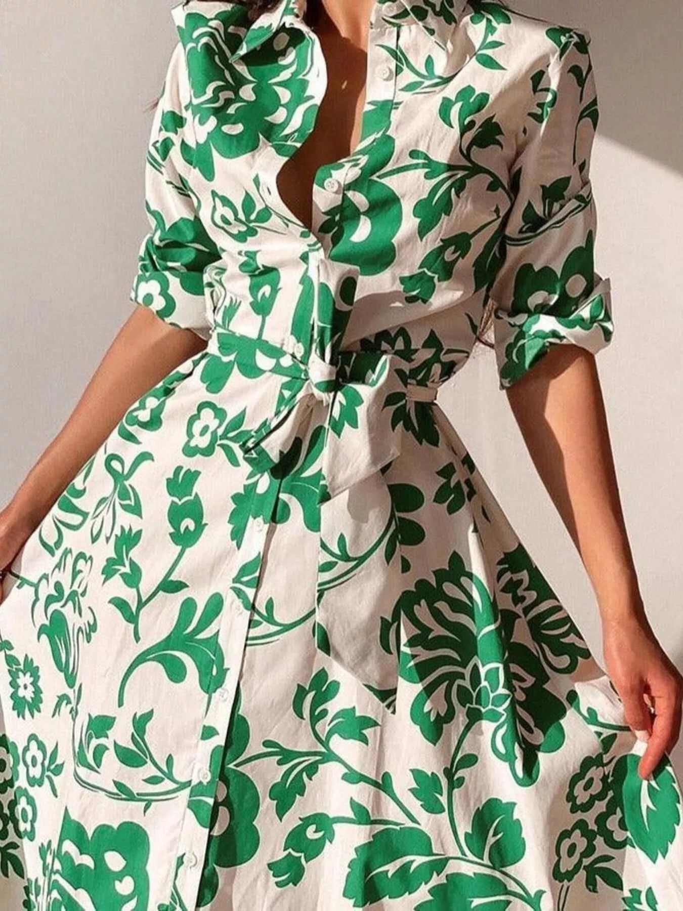 Green and white floral belted midi dress with V-neck and 3/4 sleeves, close-up