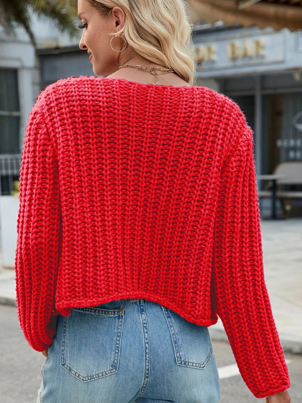 Red knit cardigan back view with textured knit fabric and round neckline
