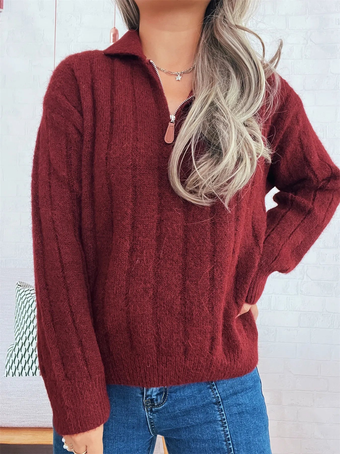 Ribbed hem quarter-zip sweater, burgundy front with zip collar and long sleeves.