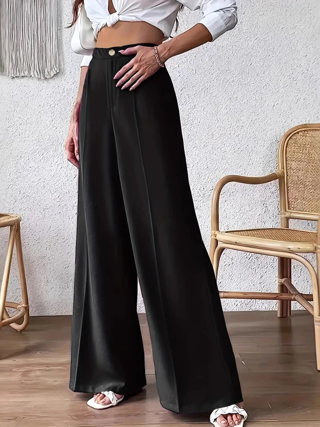Black high-waist wide-leg trousers with button front and flowing drape