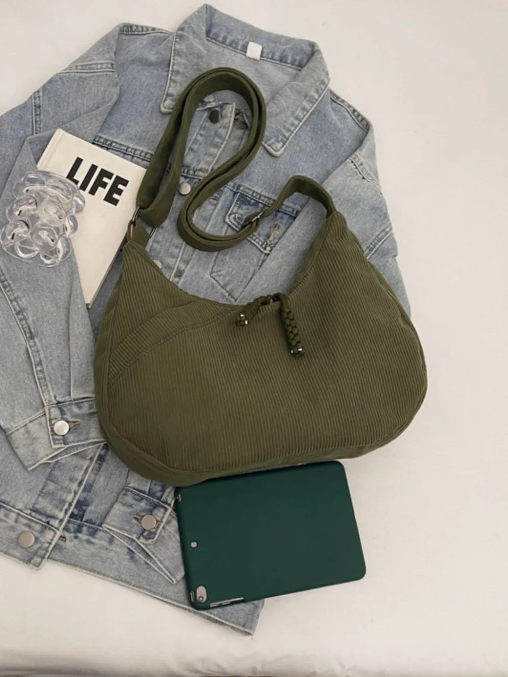 Moss green ribbed shoulder bag with braided tassel zipper pull and adjustable strap