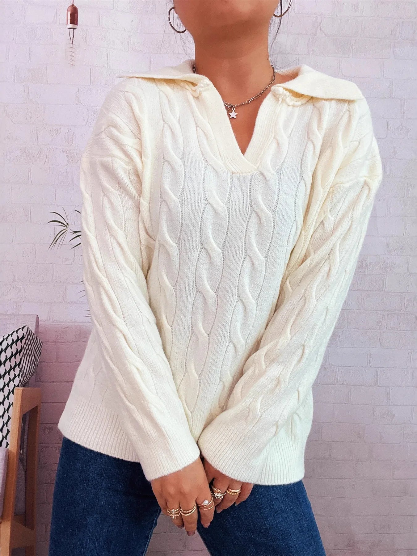 Cream cable knit Johnny-collar sweater with raised cable pattern and ribbed cuffs