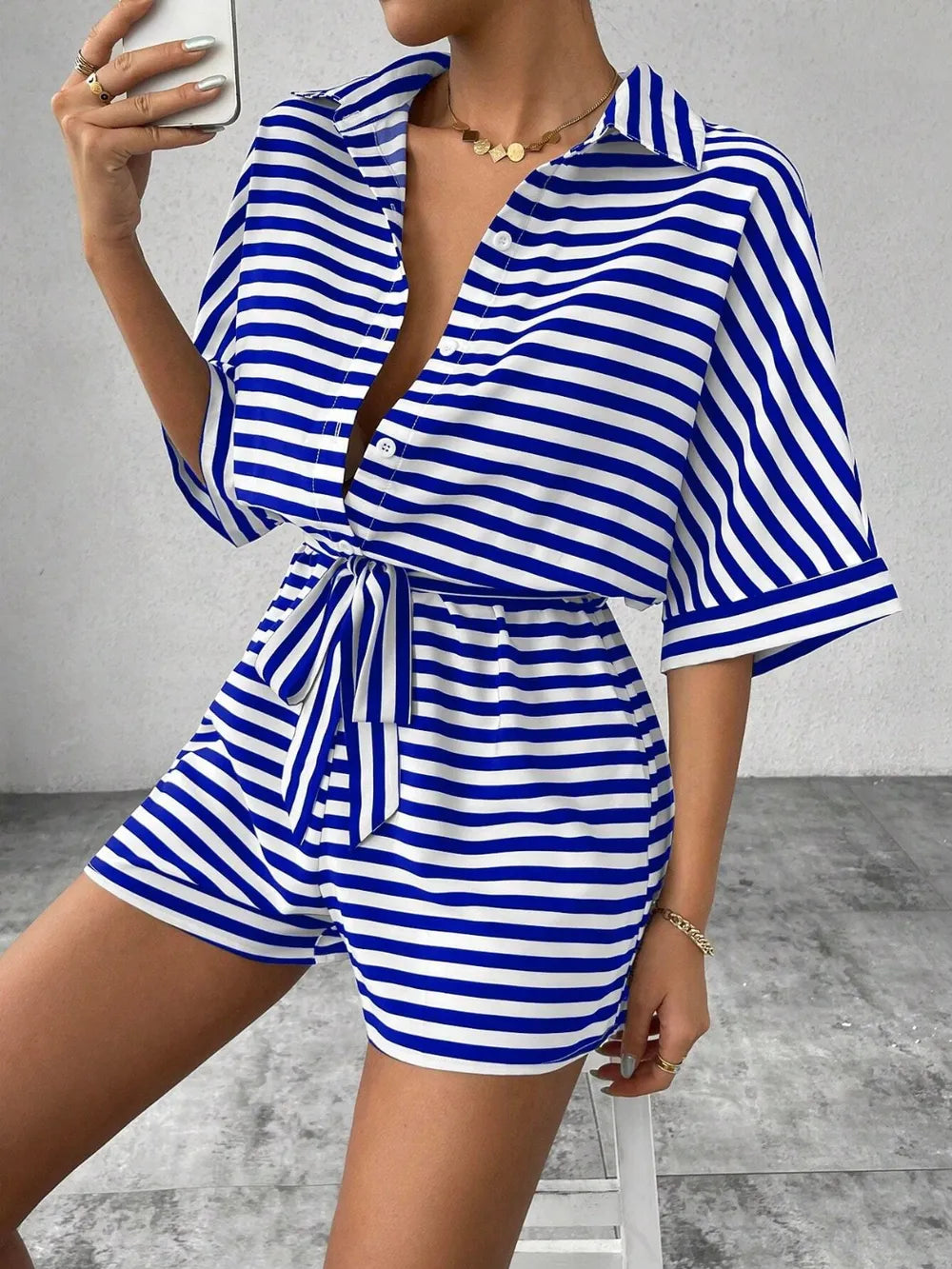Blue-and-white striped tie-waist romper with half-button V-neck and belted waist