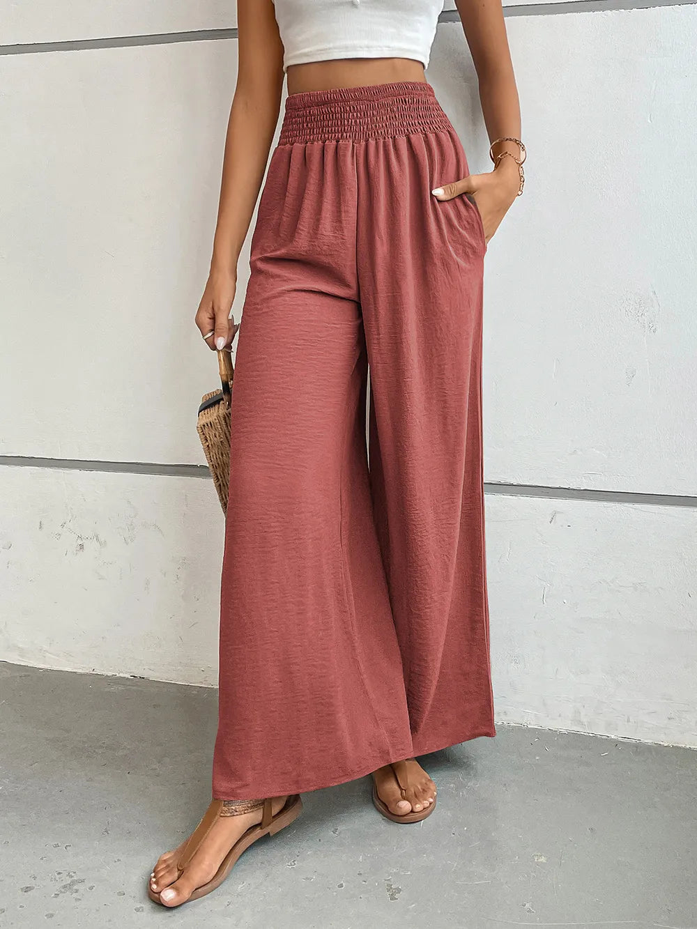 Wide-leg pants in muted rose with elastic waist and loose wide-leg silhouette