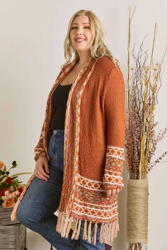 Rust aztec border cardigan with fringe hem and patterned trim across sleeves
