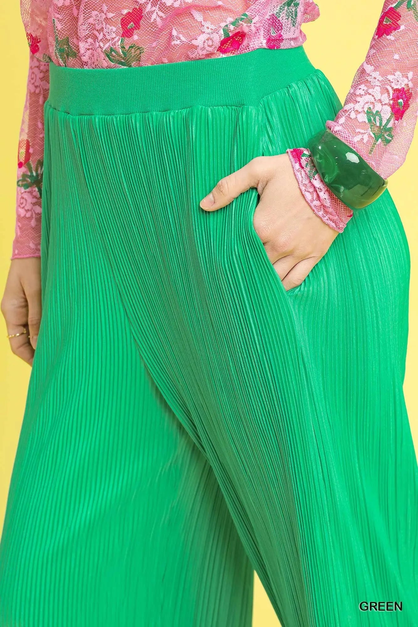 Green textured wide-leg pants with pleated fabric and elastic waist