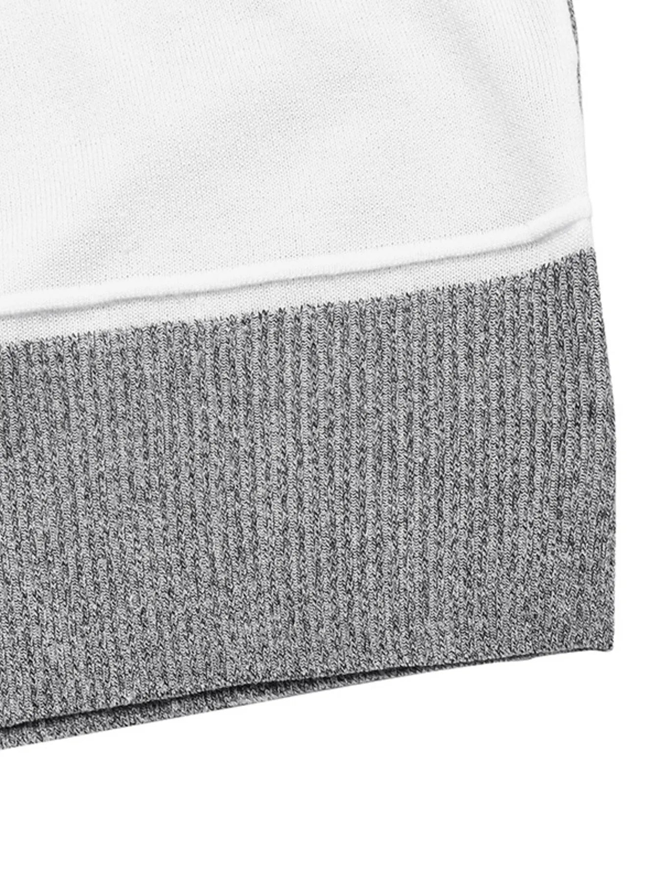 Ribbed hem trim on grey and white color-block knit sweater