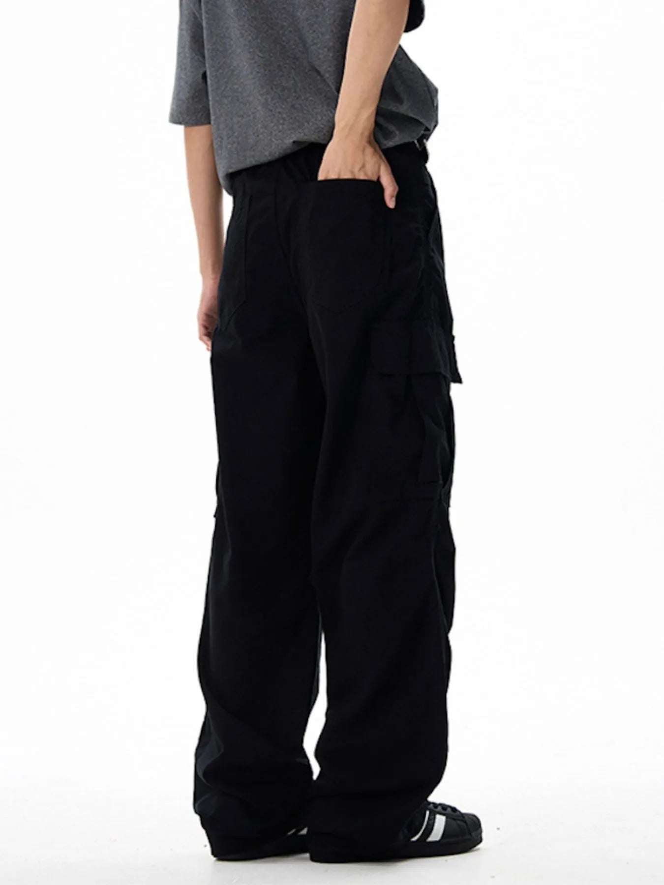 Black wide-leg cargo pants with side cargo pocket panels and belt