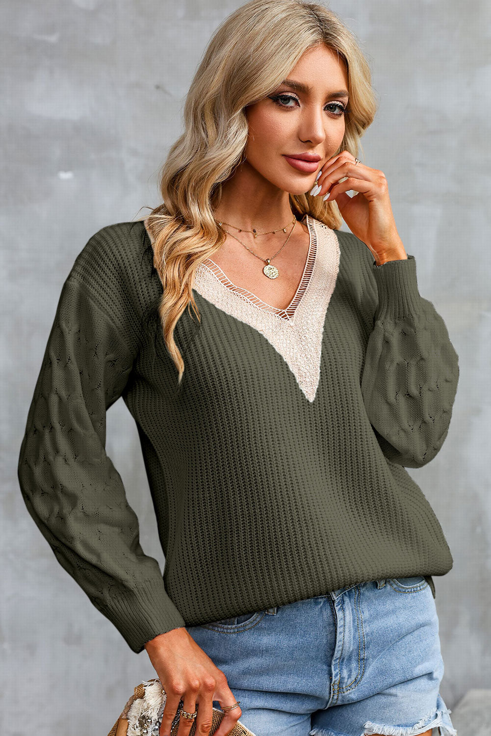 Army green V-neck sweater with cream contrast neckline and textured long sleeves