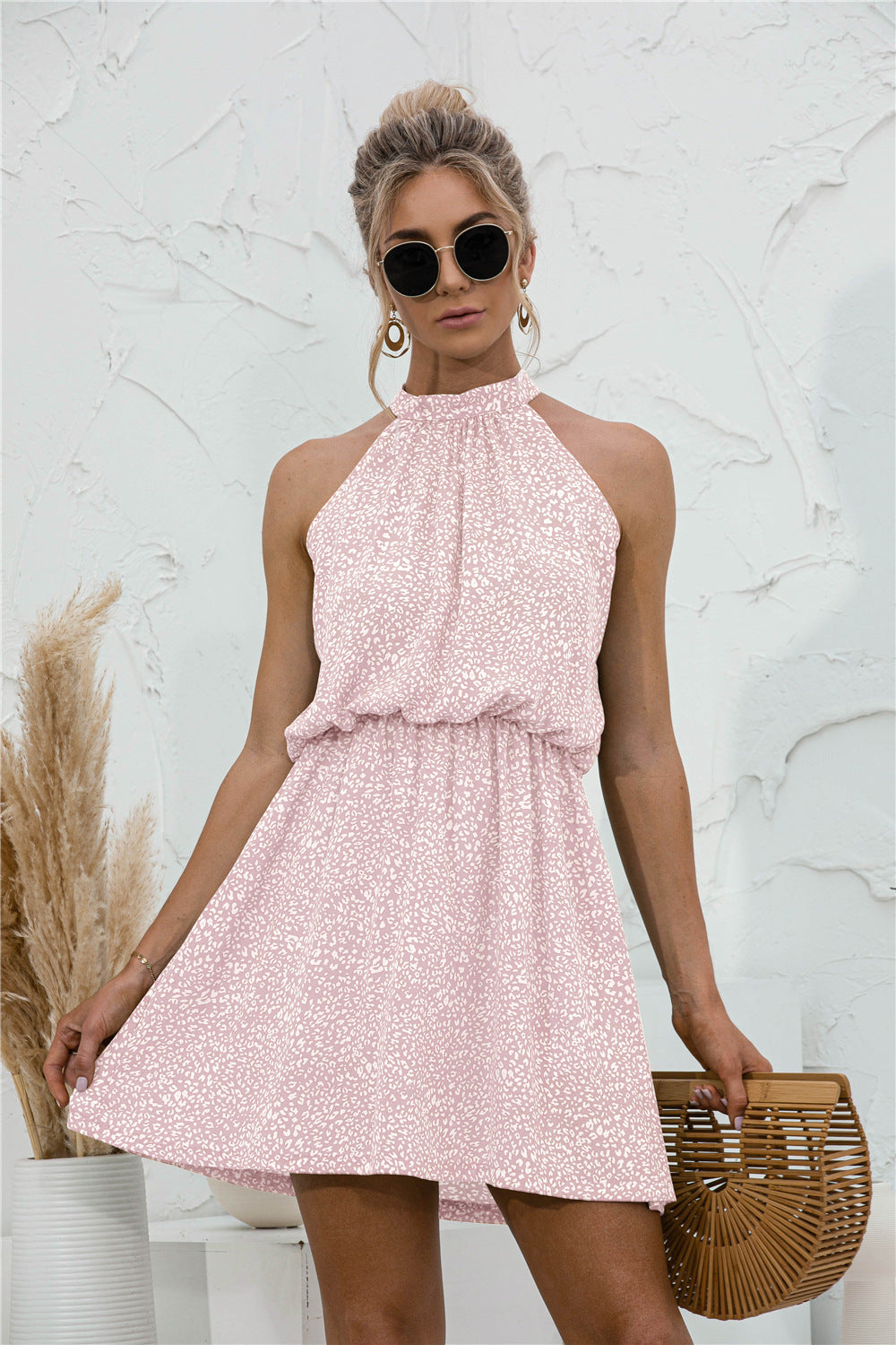 Blush pink patterned sleeveless mini dress with high halter tie neckline