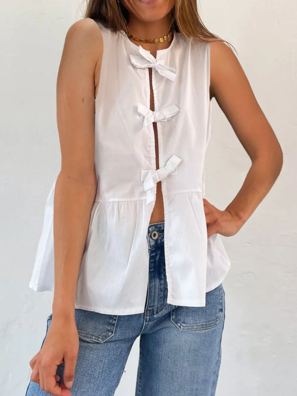White sleeveless tank top with bow-tie neckline and gathered peplum