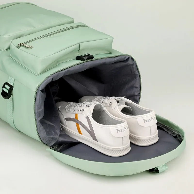 Mint green travel backpack open at top, showing interior and two sneakers inside.