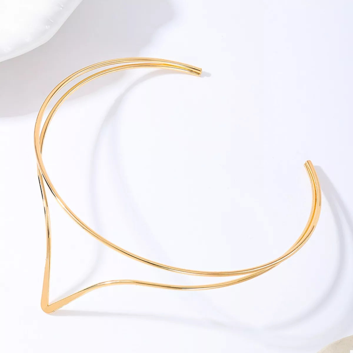 Gold double-layer V-shaped choker necklace shown from the side with V shape