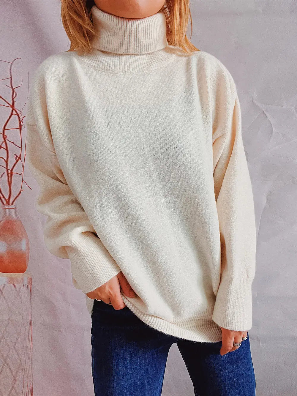 Turtleneck long-sleeve sweater in cream, front view, ribbed collar and sleeve cuffs.