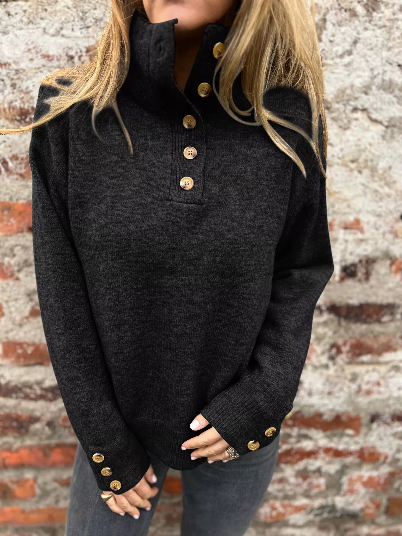 Black turtleneck sweater with button placket and long sleeves, gold-tone cuff buttons