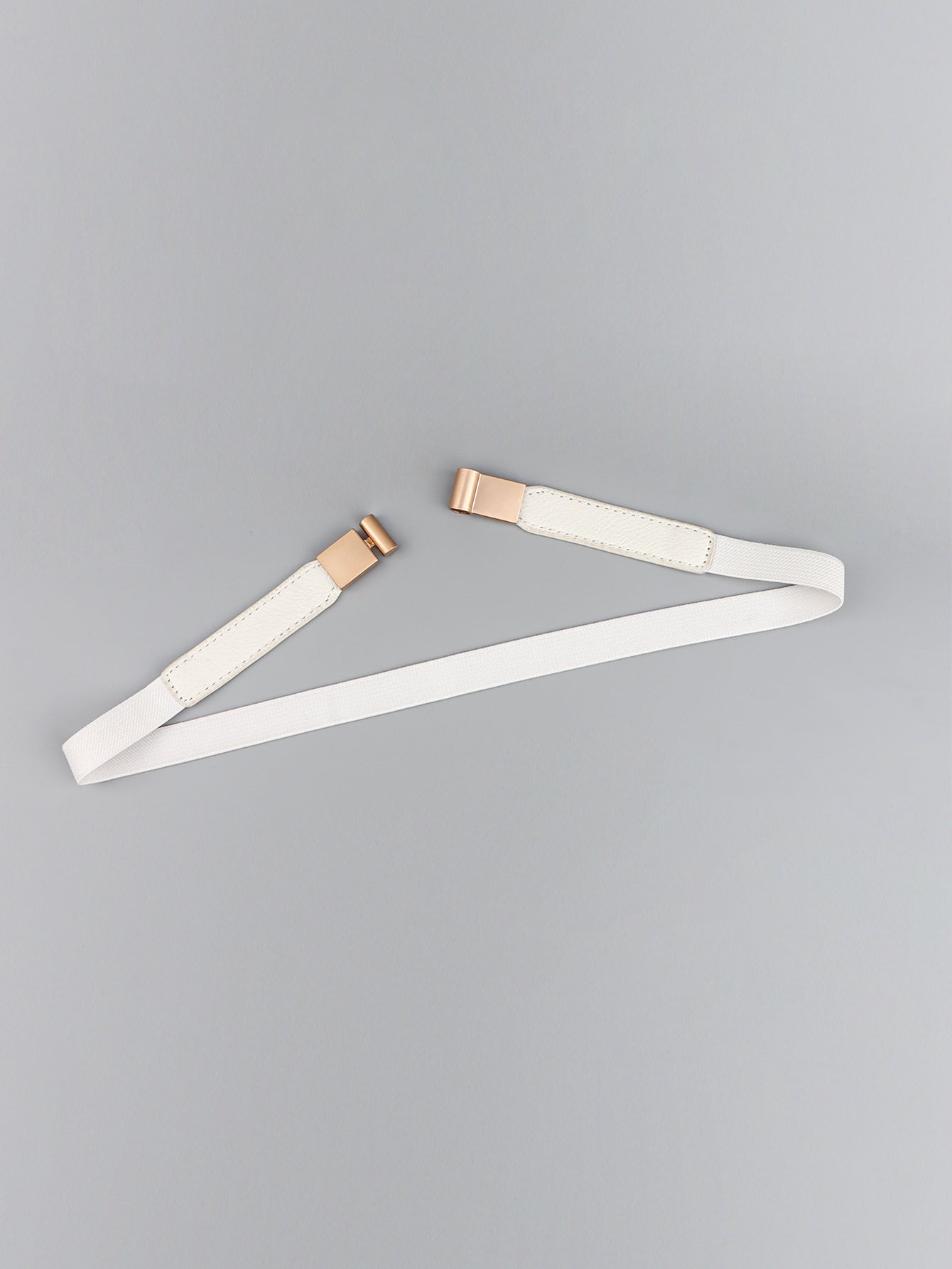 Elastic vegan leather skinny belt, white, angled with rose-gold buckle