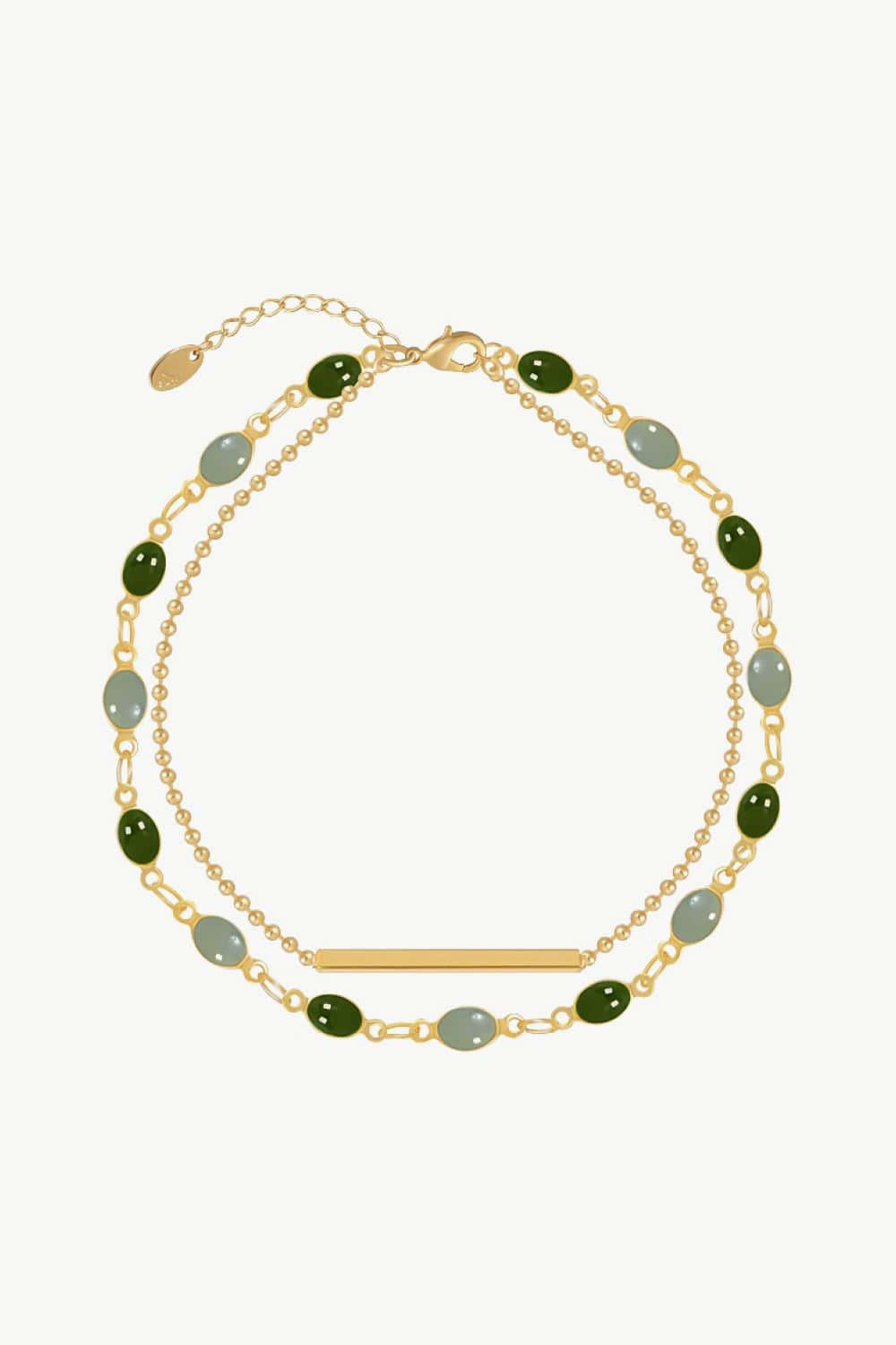 Double-layer gold-tone bracelet with green and gray oval beads and a flat bar charm