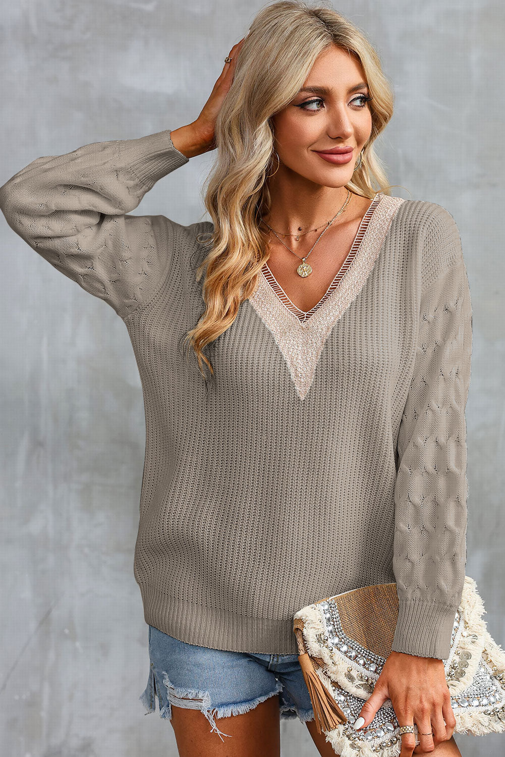 Khaki V-neck sweater with cream contrast trim and long textured sleeves