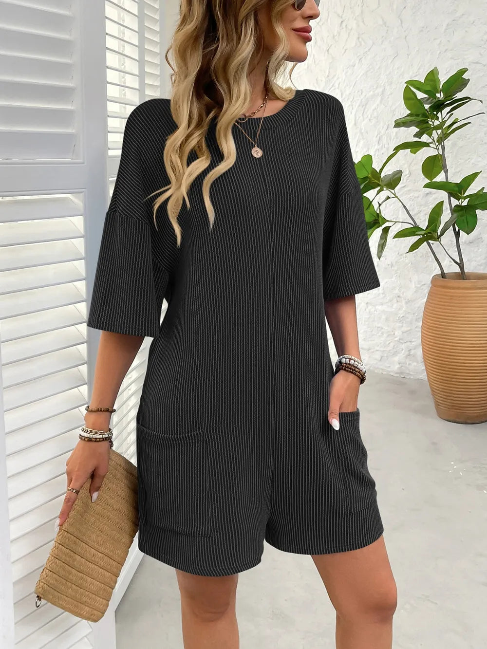 Backless textured round-neck romper, black, short sleeves, relaxed fit shorts