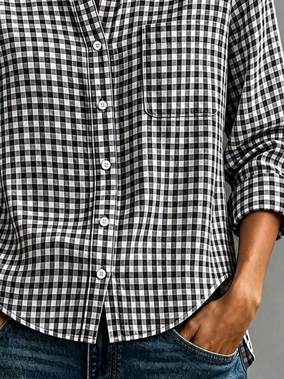 Black-and-white gingham long-sleeve button-down shirt with chest pocket and cuffs.