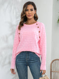 Pink long-sleeve sweater with textured knit and decorative button front