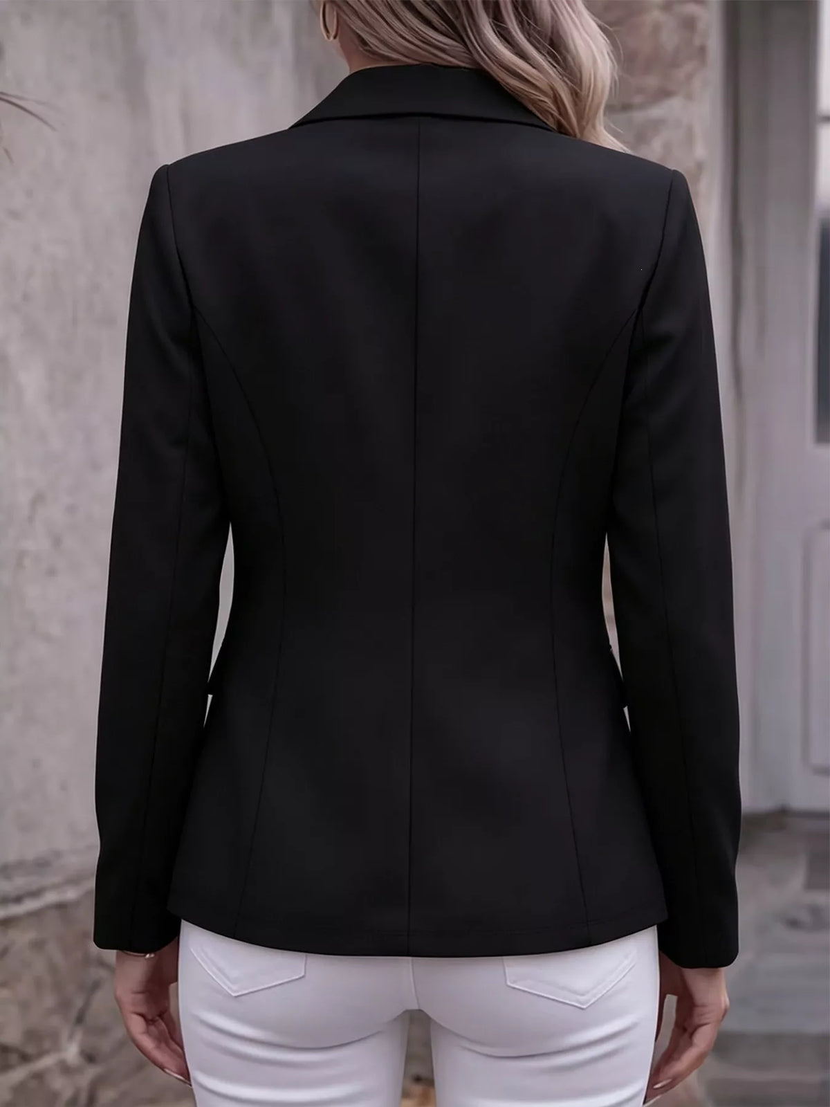 Back view of black lapel-collar long-sleeve blazer jacket with fitted back seam