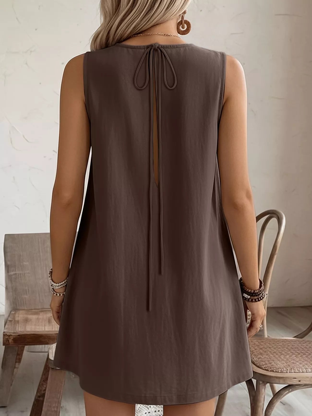 Cedar & Moore brown sleeveless dress with back tie at nape and round neck, knee-length