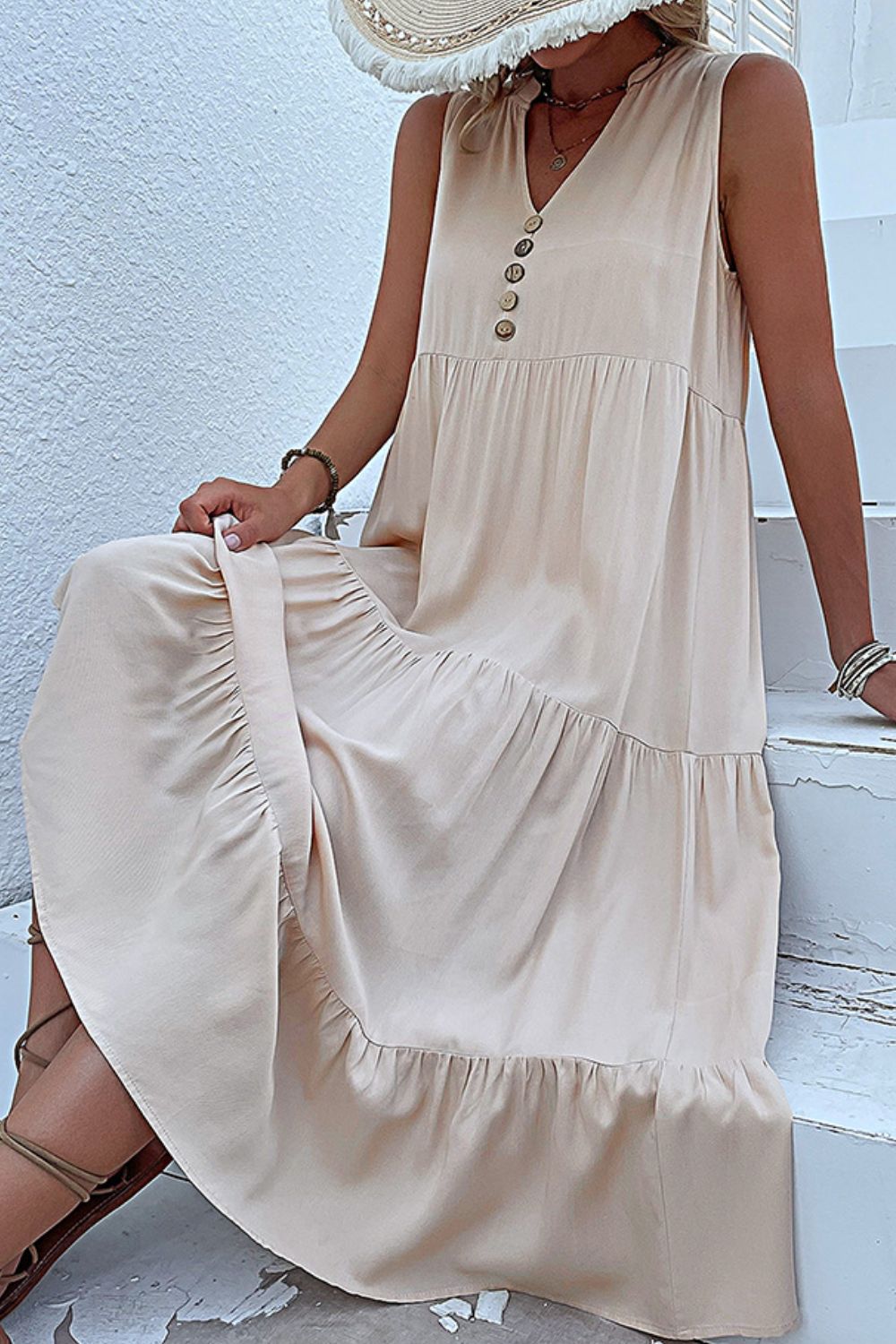 Ivory sleeveless tiered maxi dress with button placket and V-neck
