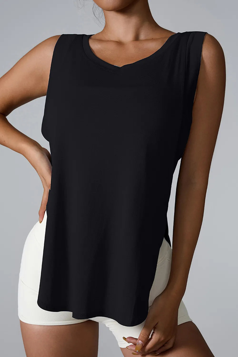 Black sleeveless active tank top with round neck and side slit at the hem