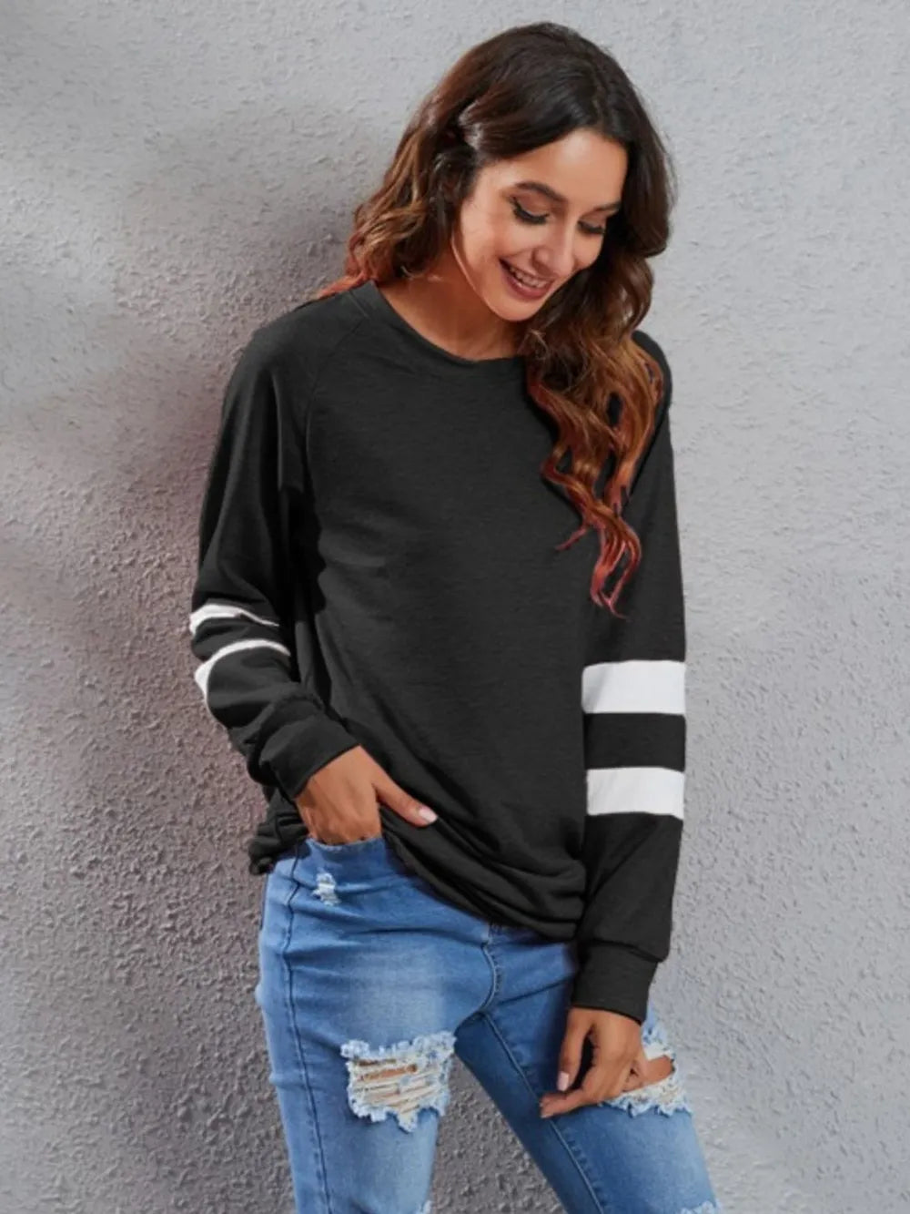 Black long-sleeve T-shirt with round neck and white striped sleeve accents