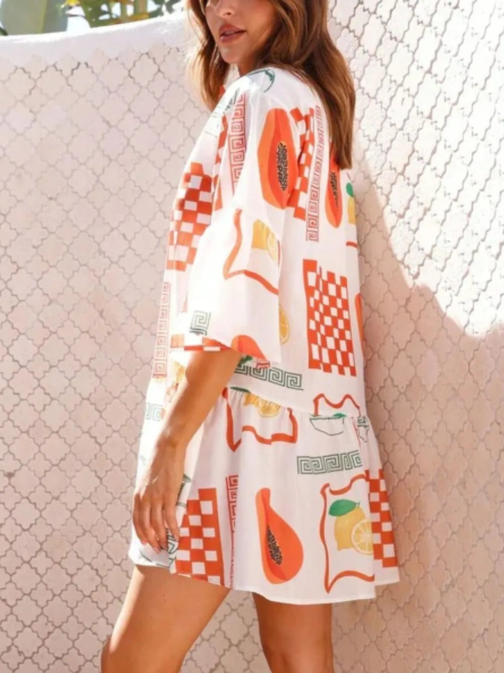 Printed mini dress in white with orange and multicolor motif blocks, three-quarter sleeves