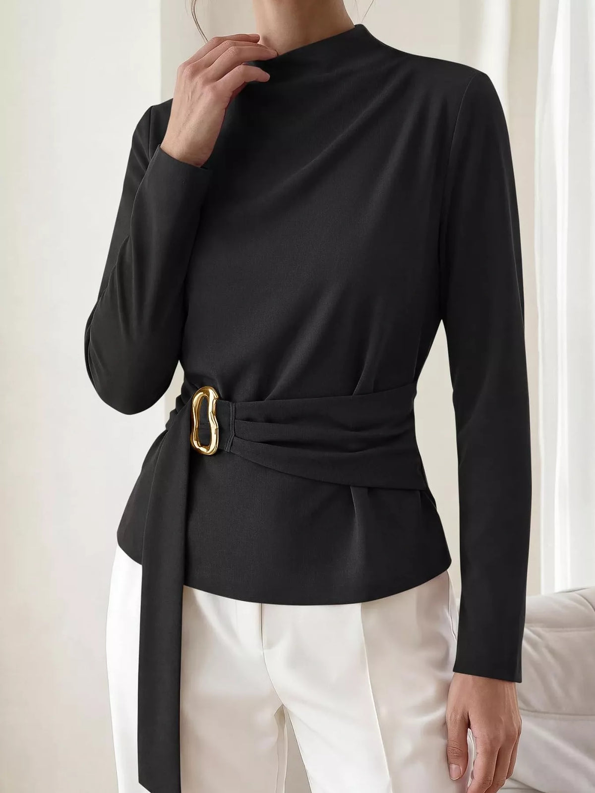 Black mock neck blouse with ruched waist belt and gold ring detail; long sleeves