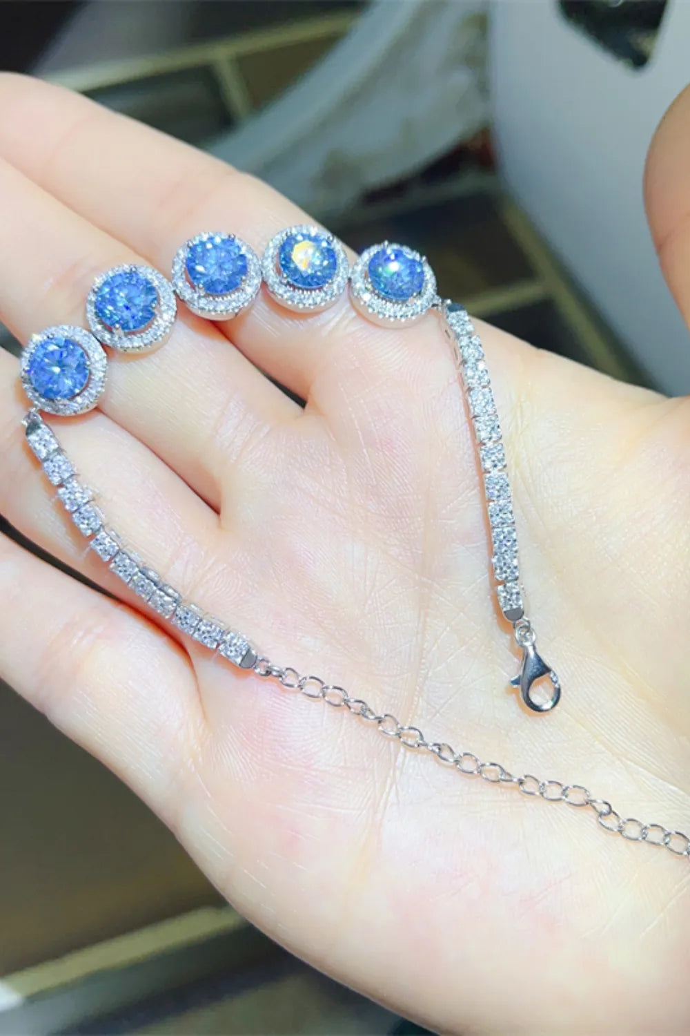 925 sterling silver bracelet with blue round moissanite stones on hand
