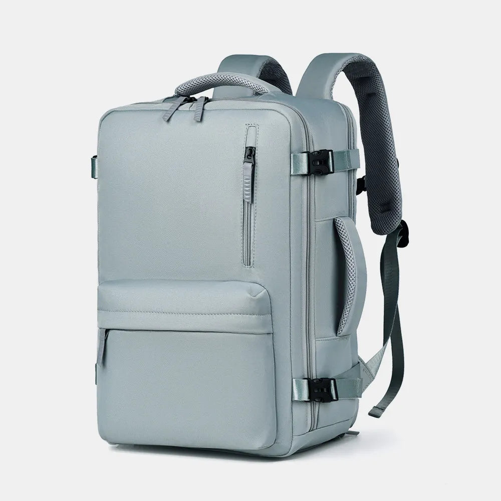 Light blue oxford backpack with front zipper, two side pockets, top handle and shoulder straps