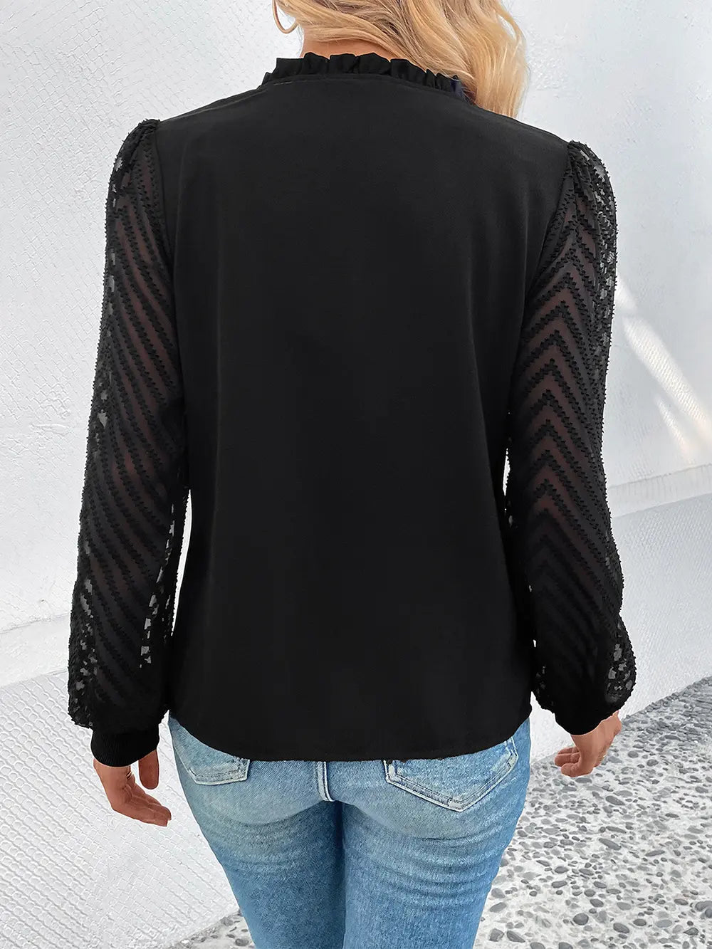 Black button-front blouse with sheer mesh long sleeves, back view