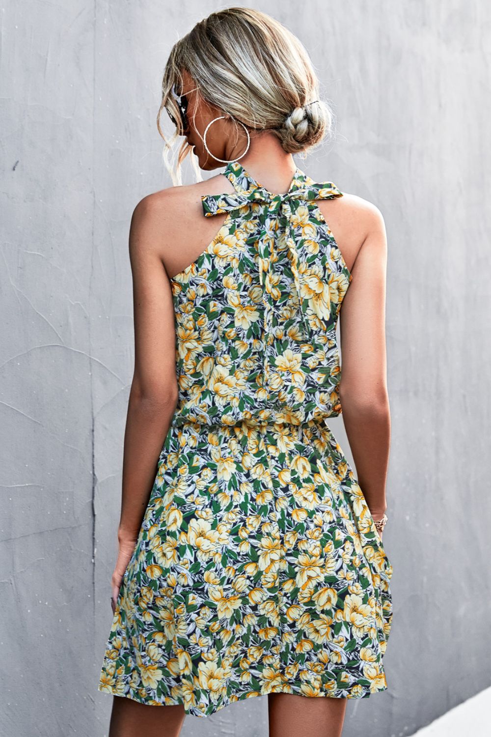 Yellow-green floral tied sleeveless mini dress with ruffled halter neckline