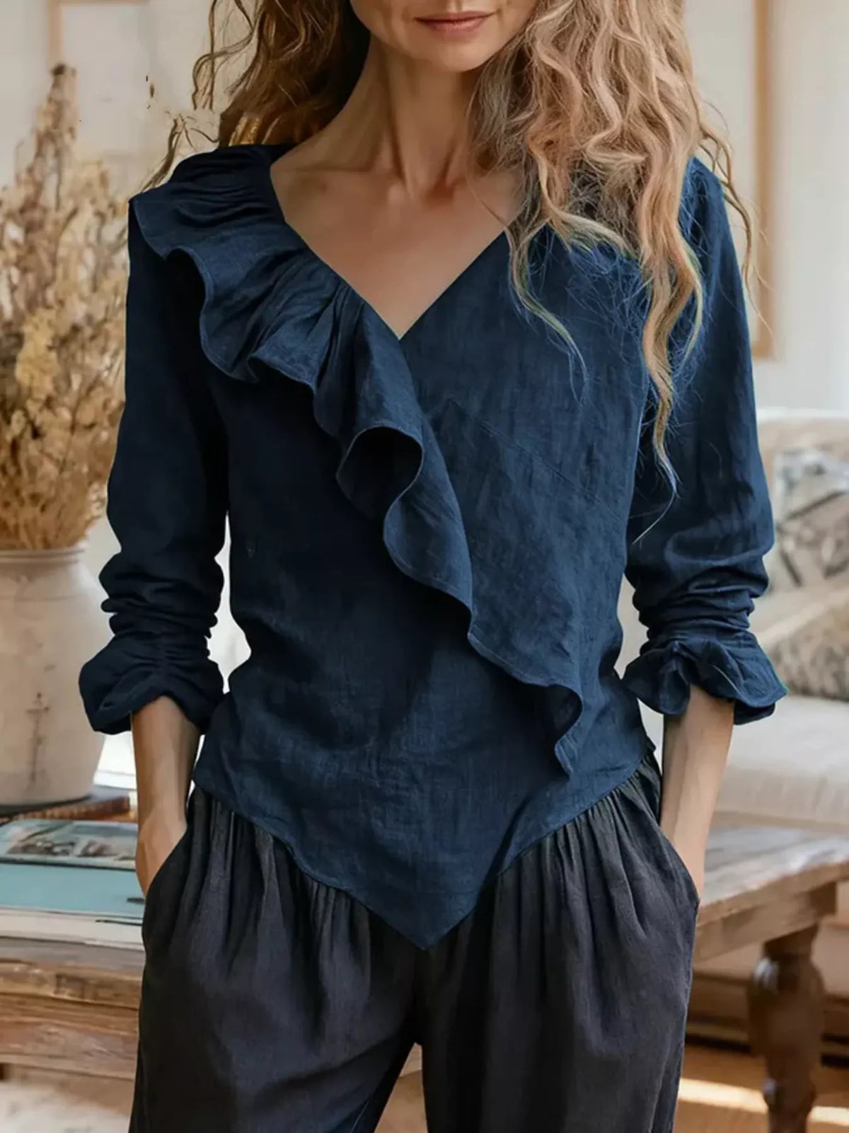 Navy ruffled V-neck long-sleeve blouse with layered front ruffle and peplum hem