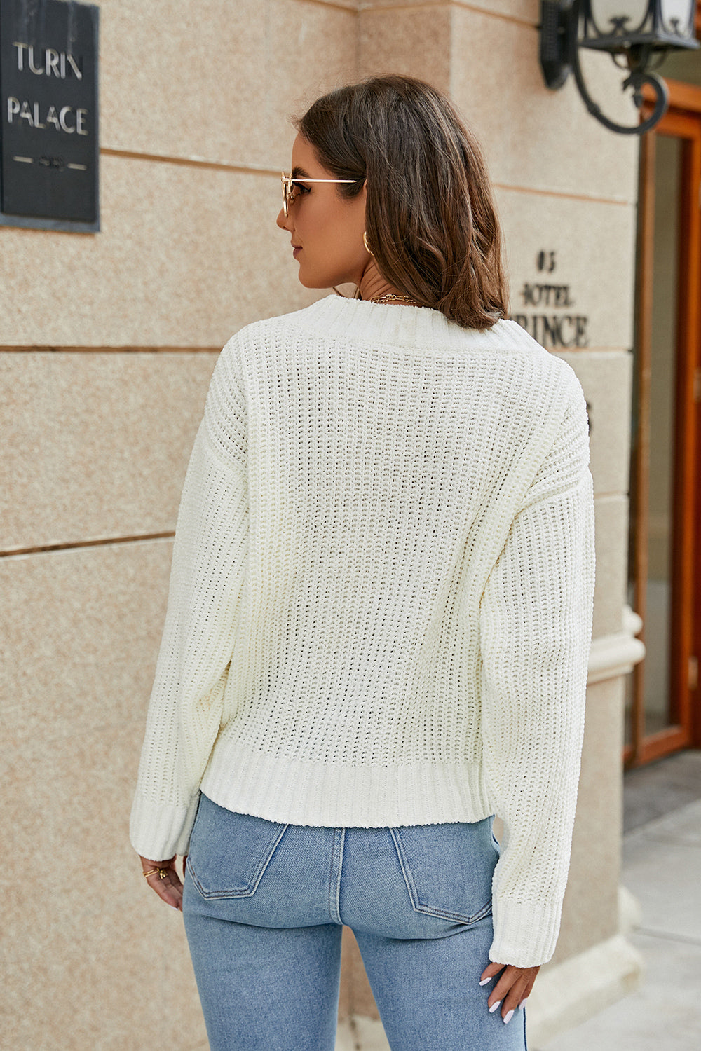 White openwork knit surplice sweater, long sleeves, V-neck in back view