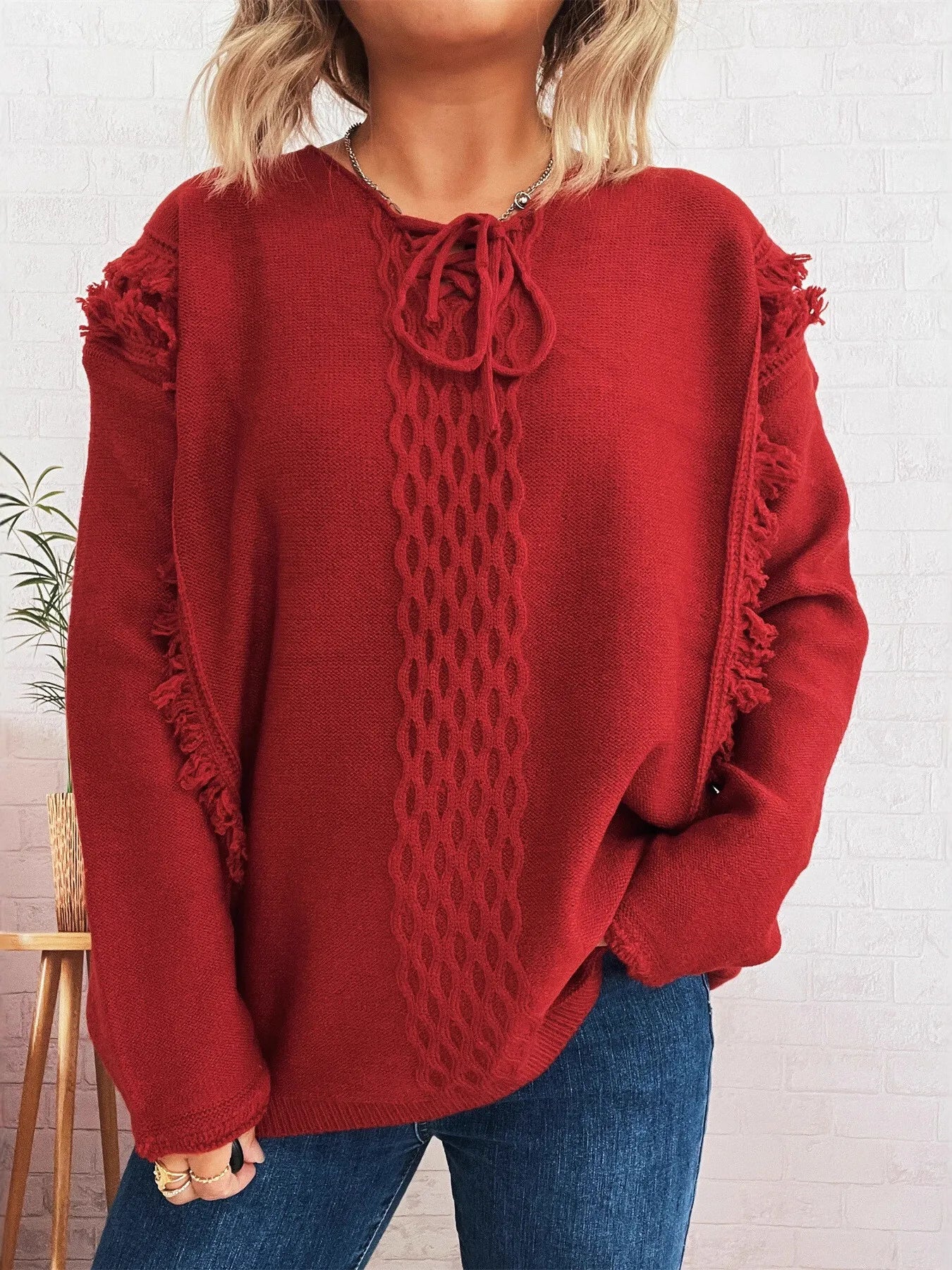 Burgundy raw-hem lace-up sweater with cable knit front and fringe sleeves